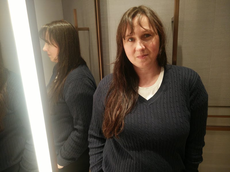 Art and Design Critic Sylwia Dziuba standing next to a mirrored wall